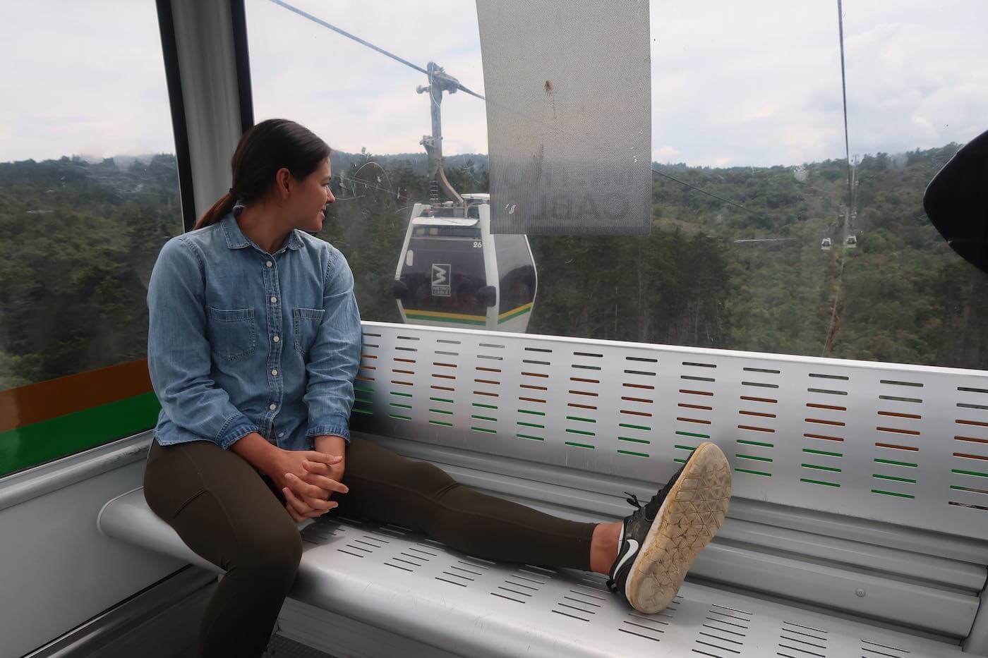Kim sitting in Metrocable over Parque Arvi