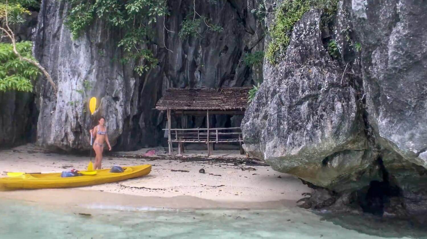 Kim and the kayak on a little beach on Coron Island.