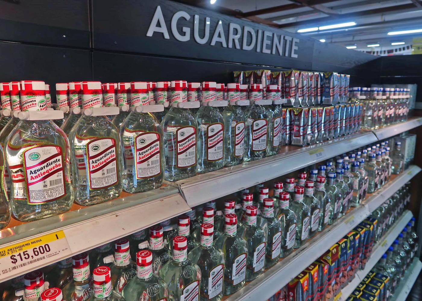 A shelf of aguardiente at Exito supermarket in Medellin