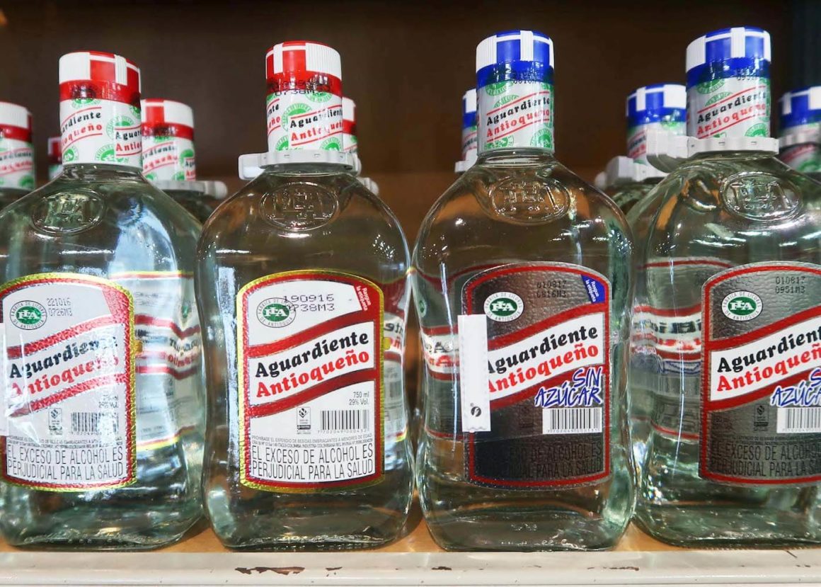 Side by side of red and blue cap aguardiente Antioque?o