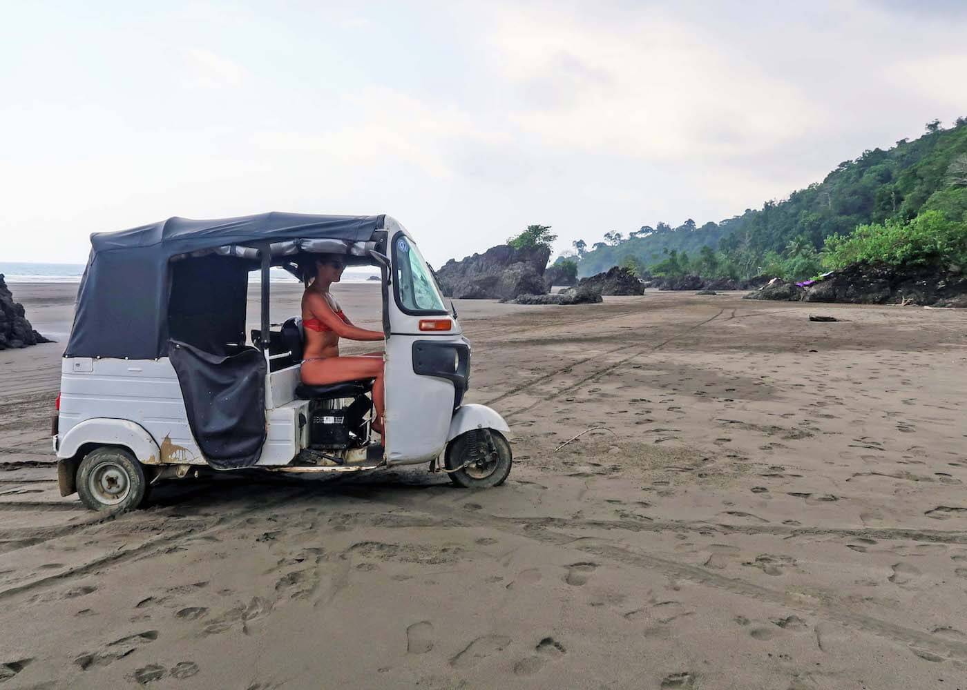 Kim driving a tuk-tuk on Playa El Almejal, which is highlighted in our list of things to do in El Valle, Choco, Colombia