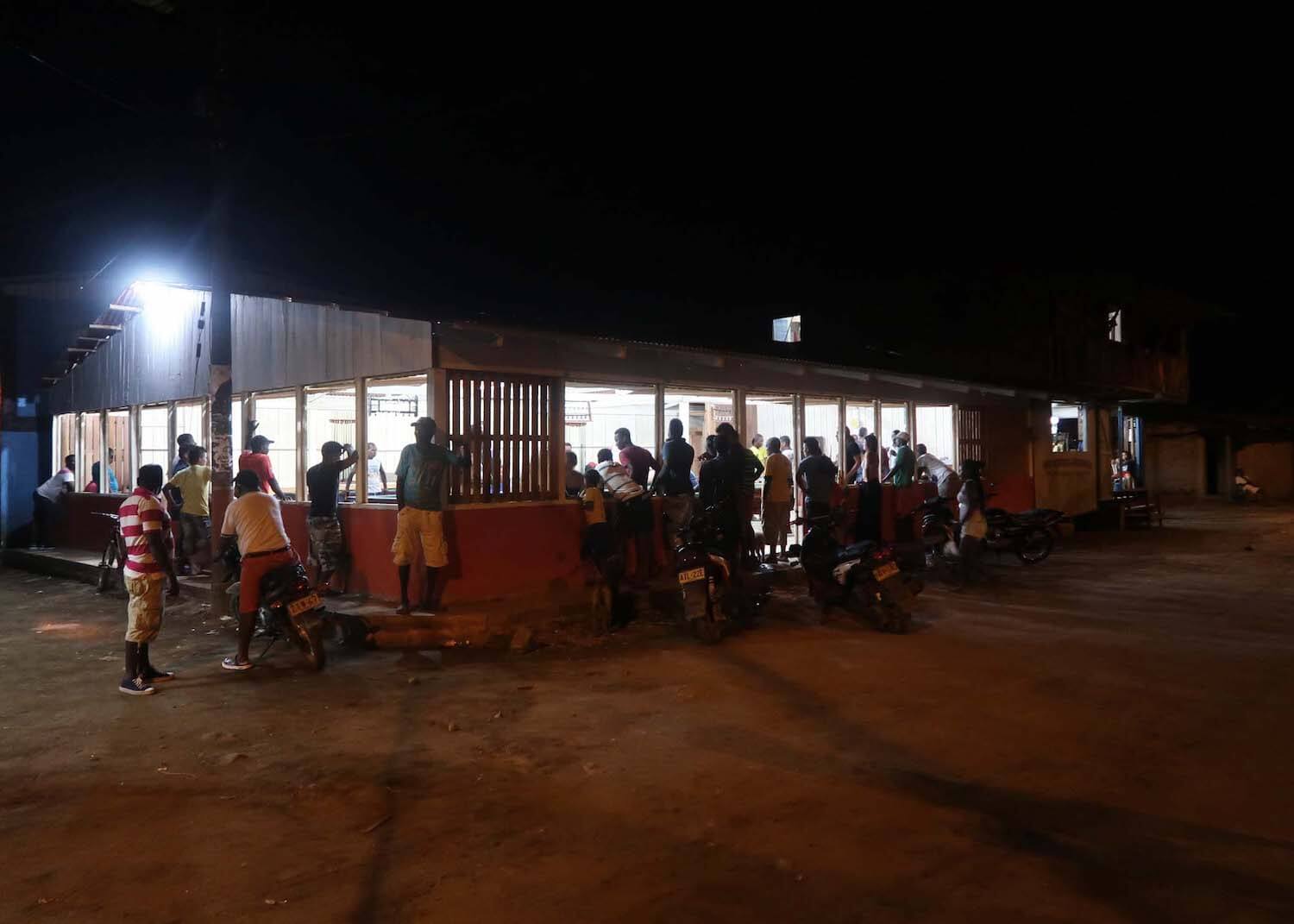 Spectators crowding outside El Valle's pool hall, the top thing to do in El Valle at night.