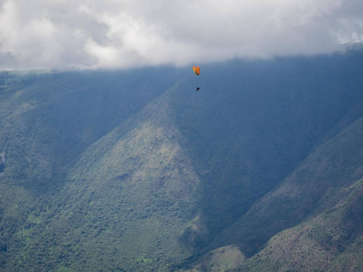 Chris paragliding high in the sky