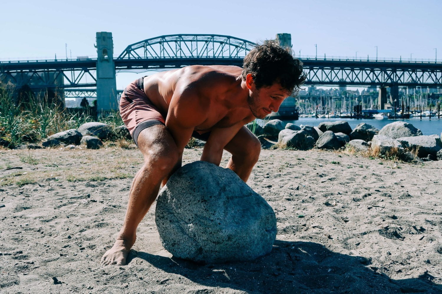 Chris rolling boulder at Sunset Beach in Vancouver.