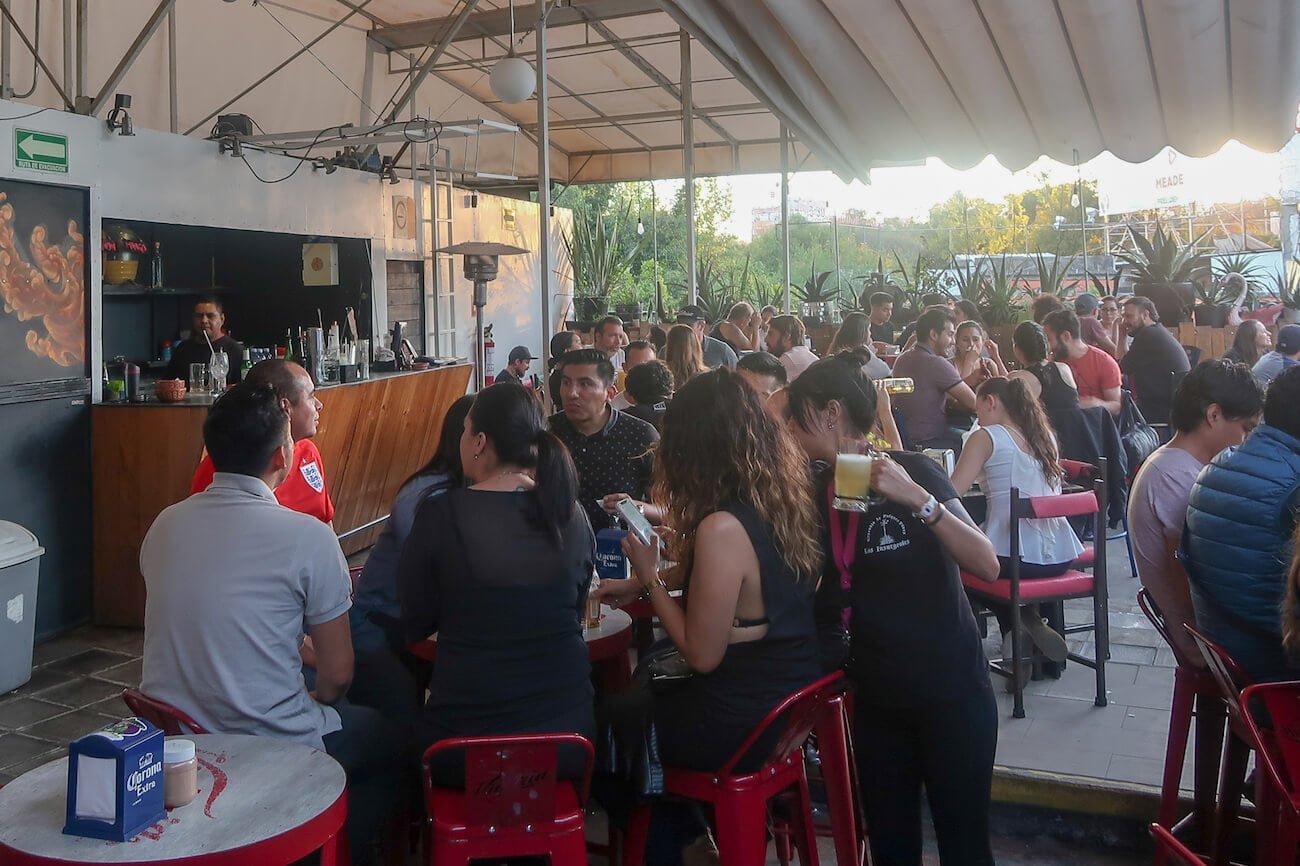 Busy rooftop bar at Pulqueria Insurgentes