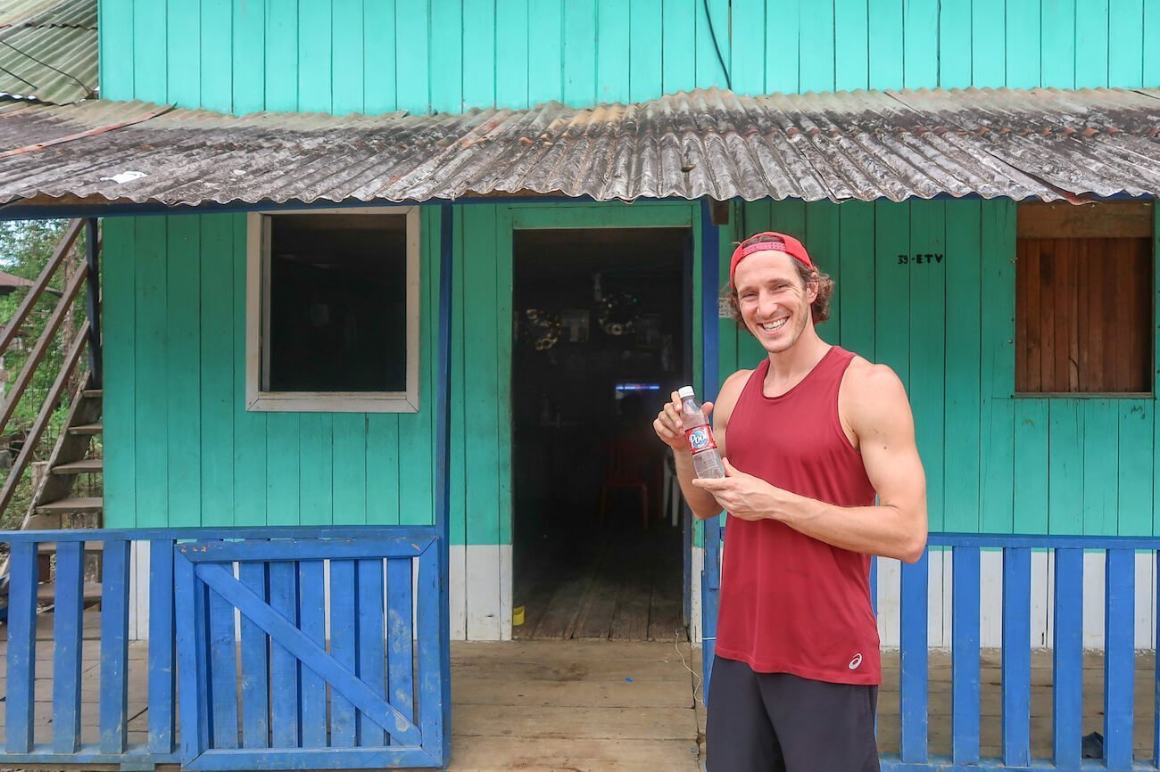 Chris holding a bottle of viche, a home-brewed alcoholic Colombian drink