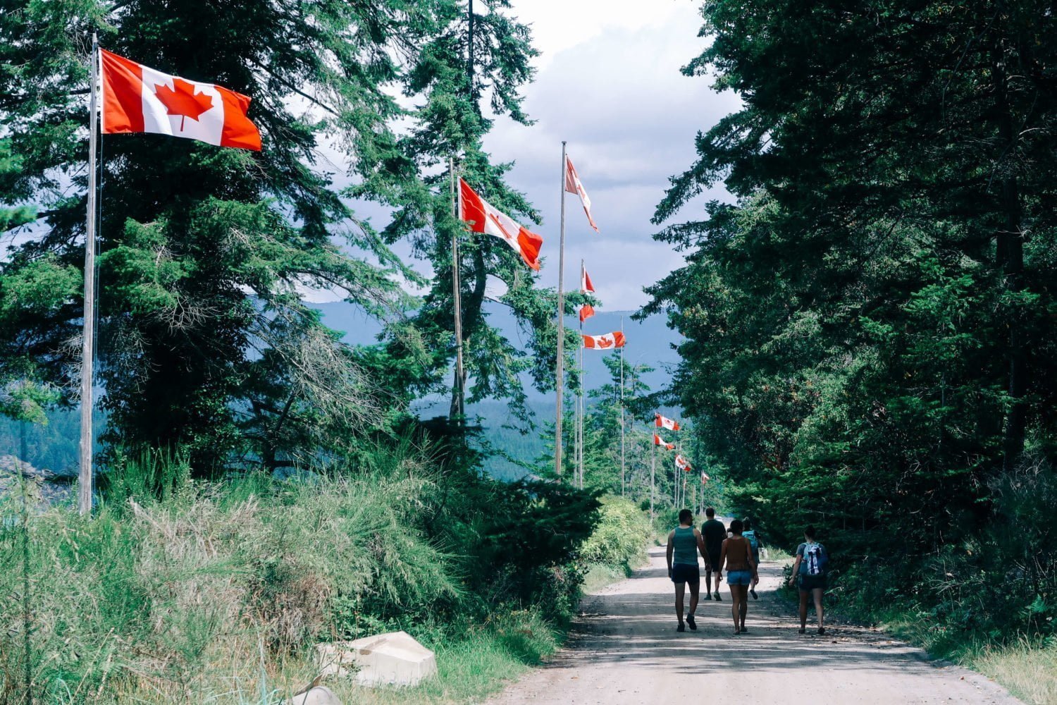 walking along savary island's beachfront with canadian flags