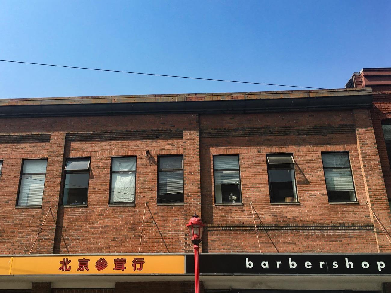 Chinese storefront beside barbershop