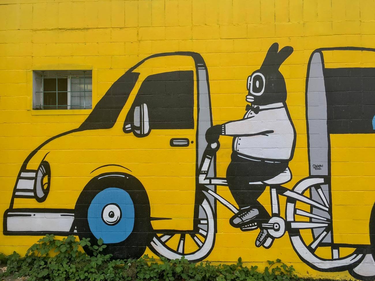 Street art of biker in car
