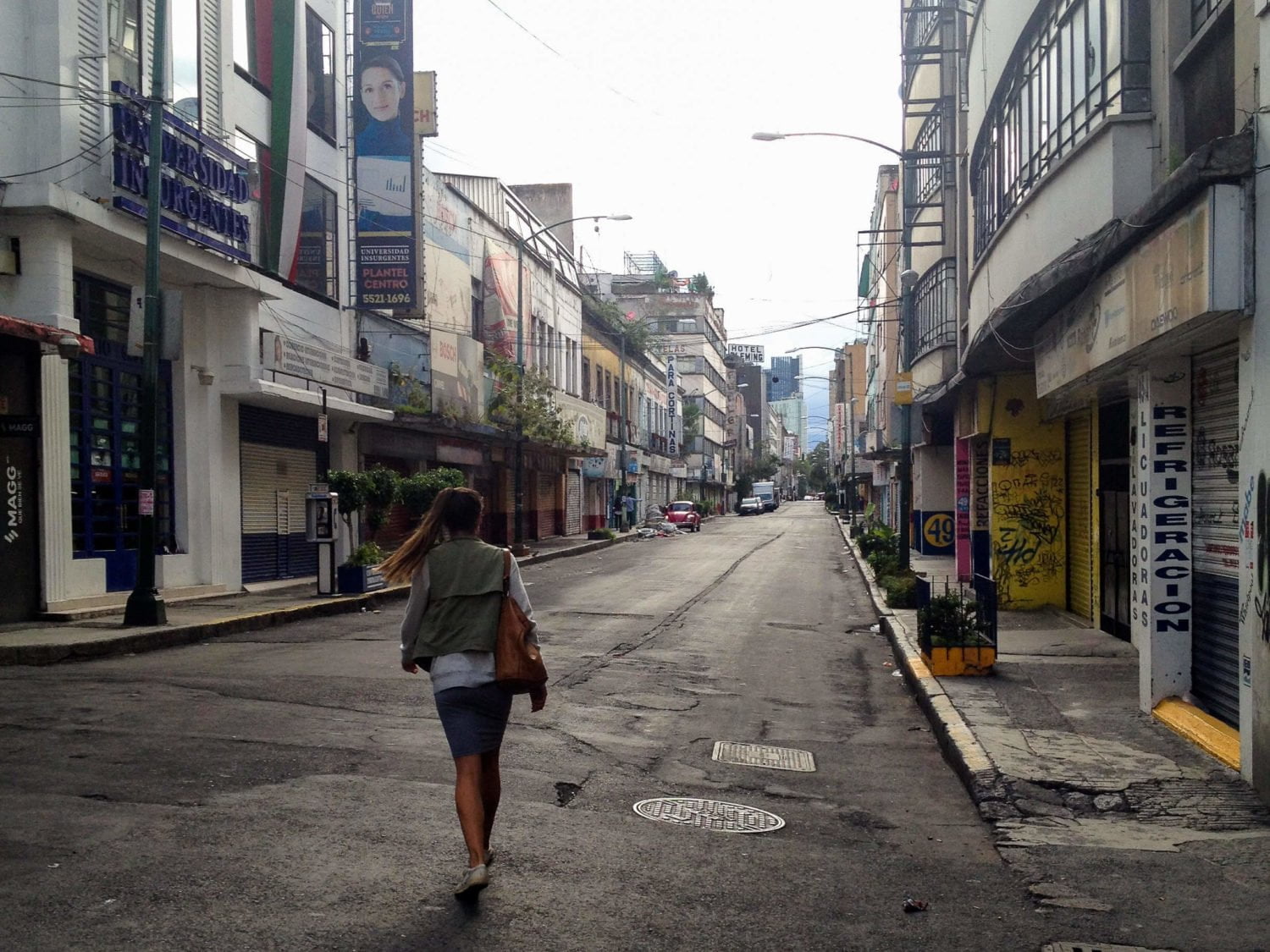 kim walking downtown on empty street mexico city