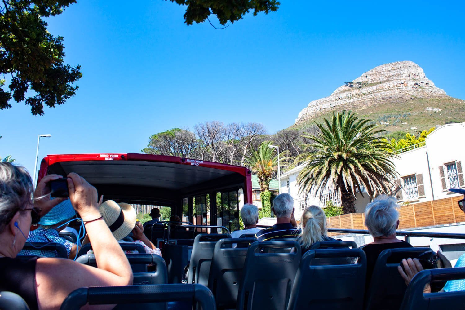 Tourists looking at Lions Head from the hop on hop off bus