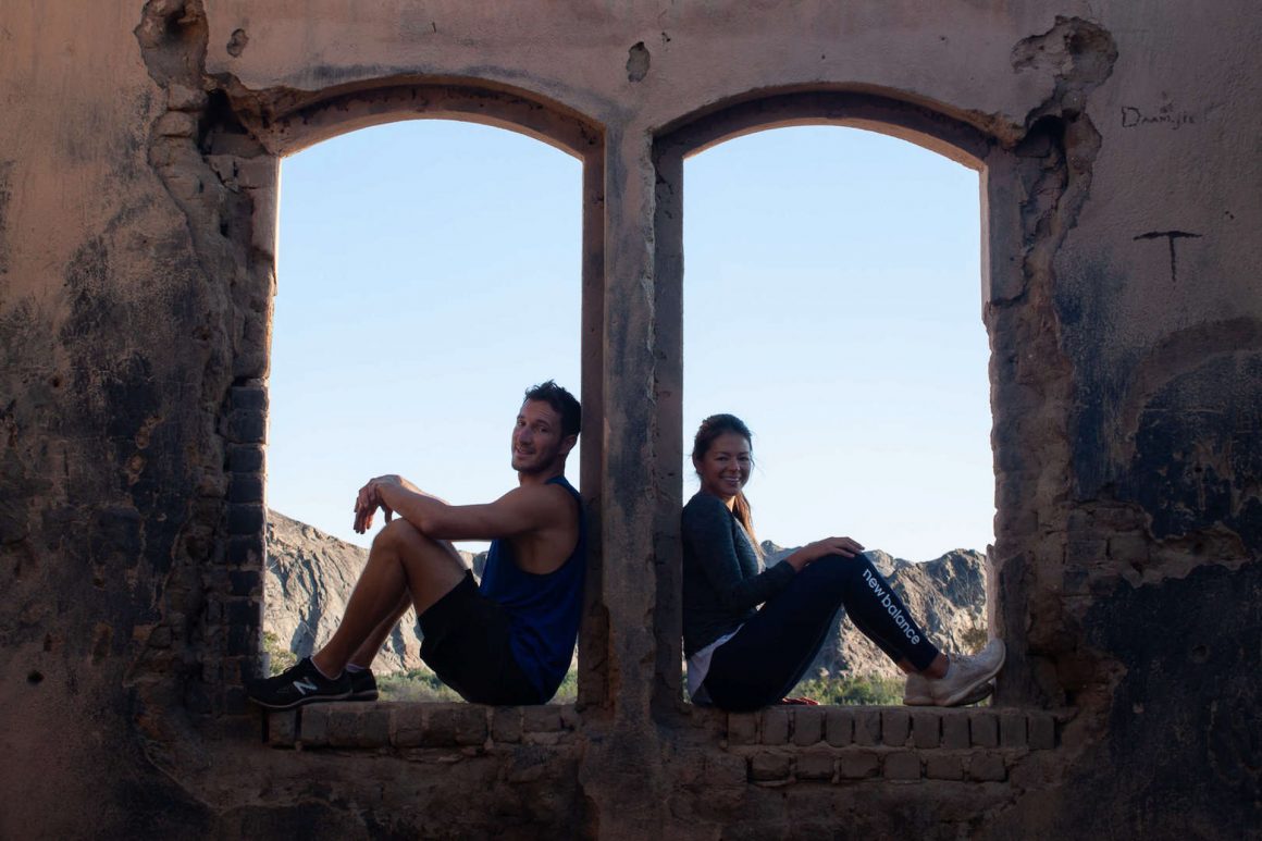 Chris and Kim sitting in an abandoned house by Goanikontes in Swakopmund