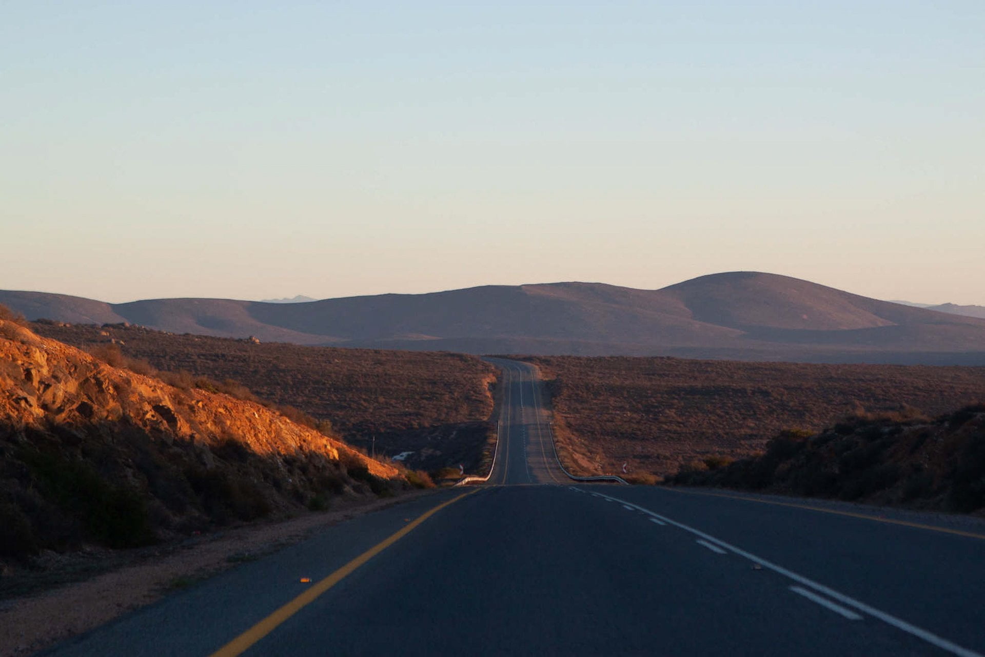 South Africa Road trip tips cover of sunrise view of highway driving towards the Namibian border.
