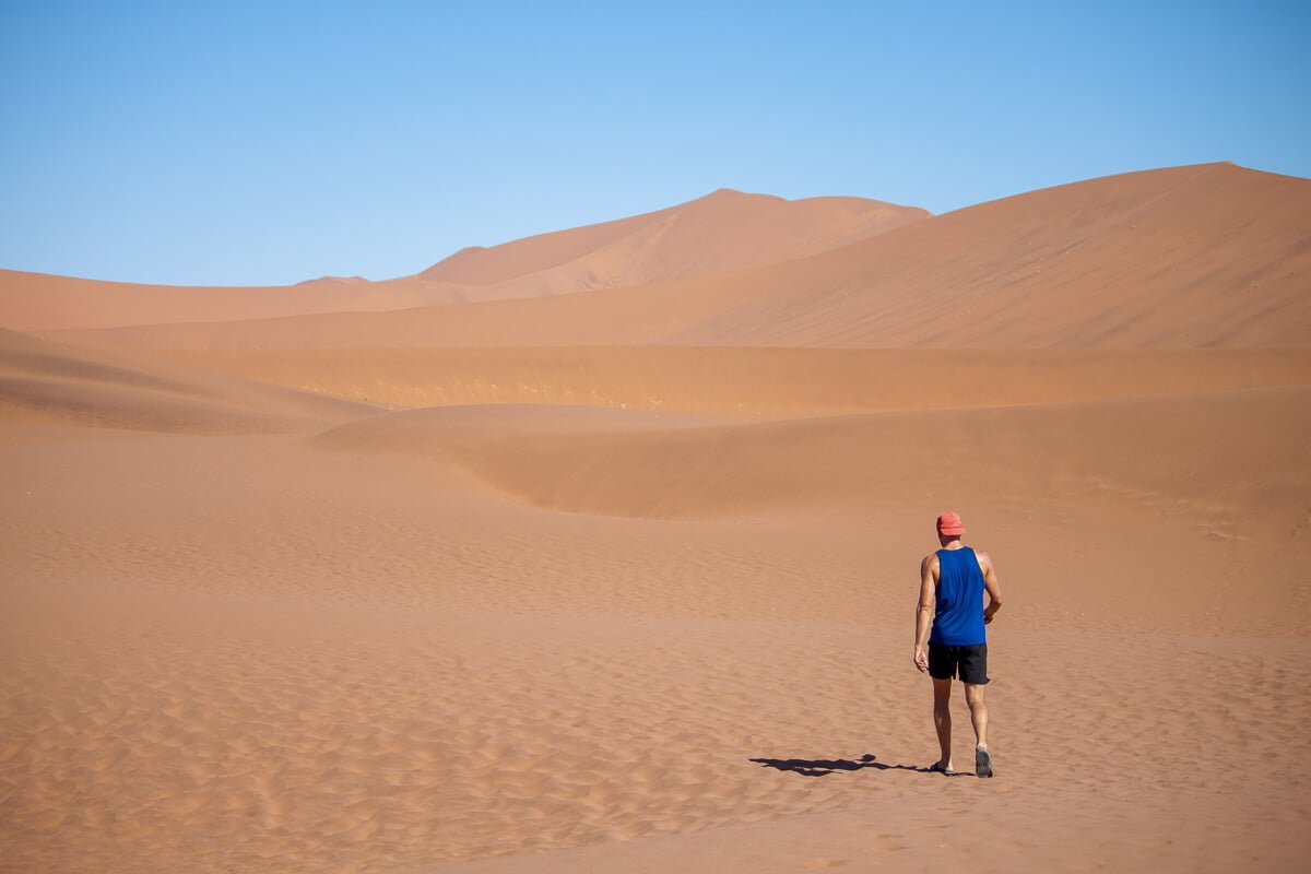 Chris walking in his Icebreaker tank top in the Namibian desert at Sossusvlei