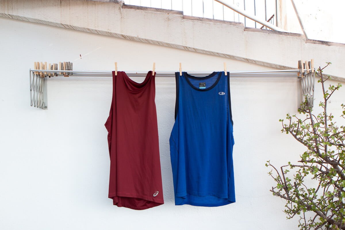 Merino wool and synthetic shirts hanging side-by-side
