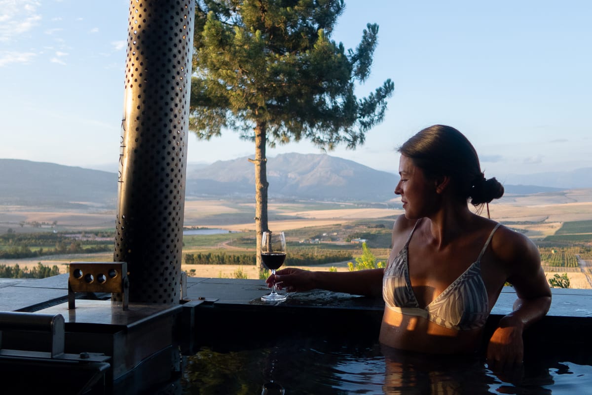Kim about to take a sip of wine inside our Airbnb's wood-fired hot tub in Bot River, just outside of Cape Town.